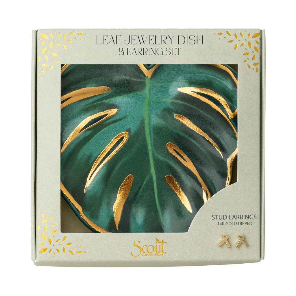 Leaf-shaped jewelry dish with gold accents and small gold stud earrings in a gift box