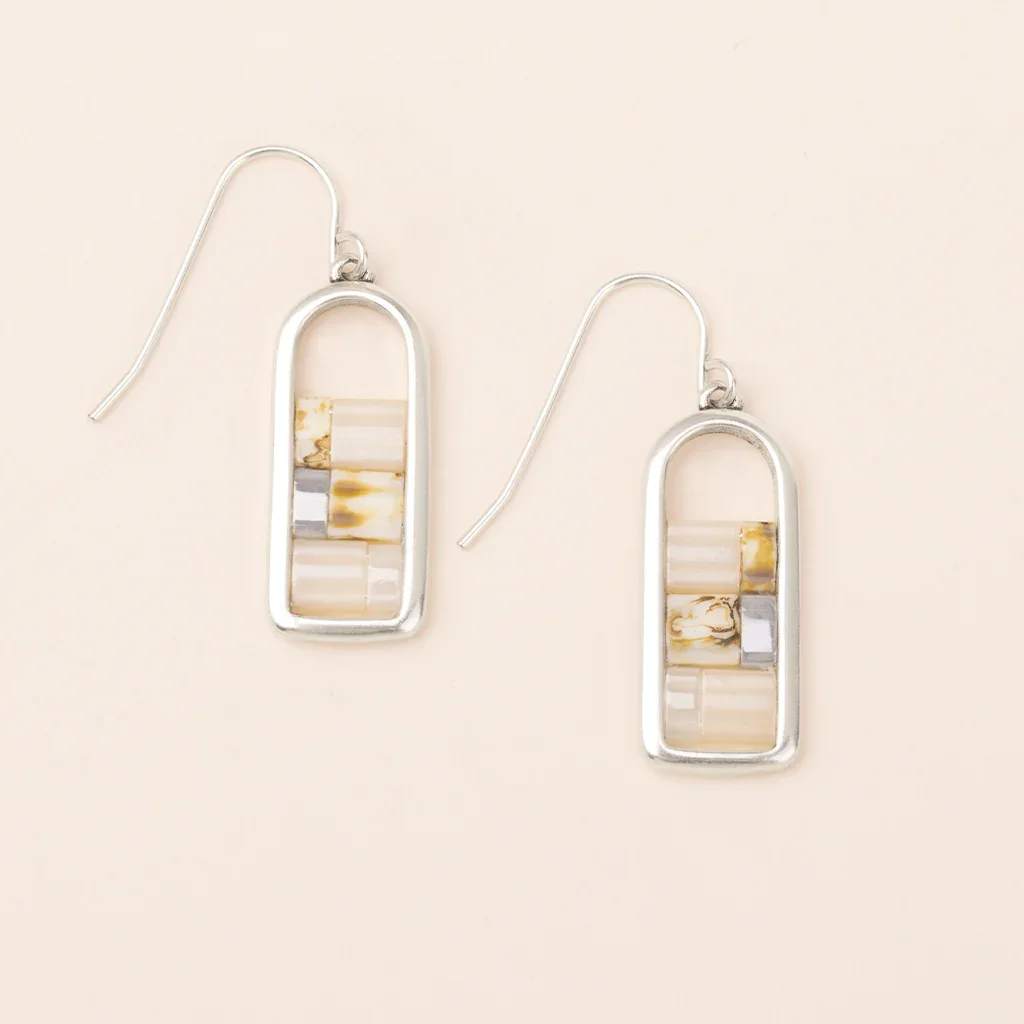 Pair of rectangular silver drop earrings with neutral marbled inlays on a light background