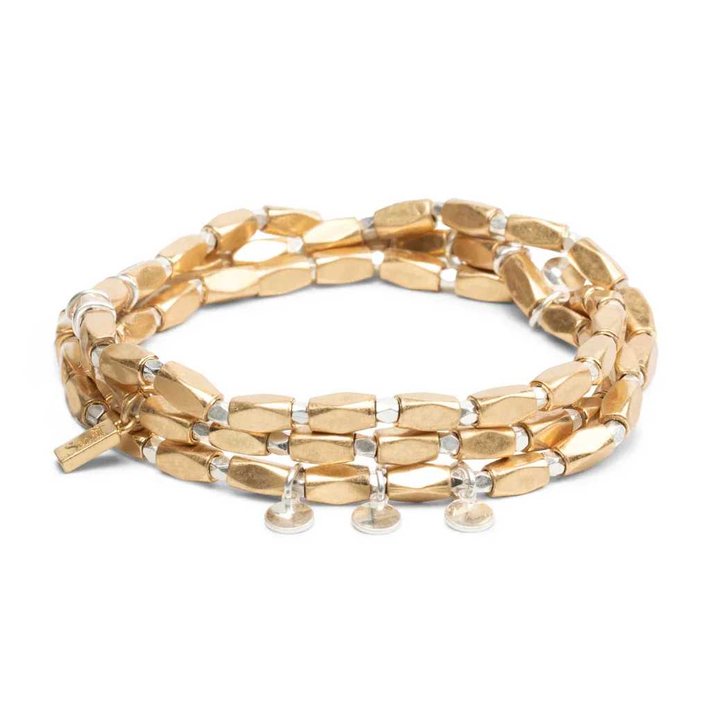Gold and silver beaded wrap bracelet with small clear disc charms on white background