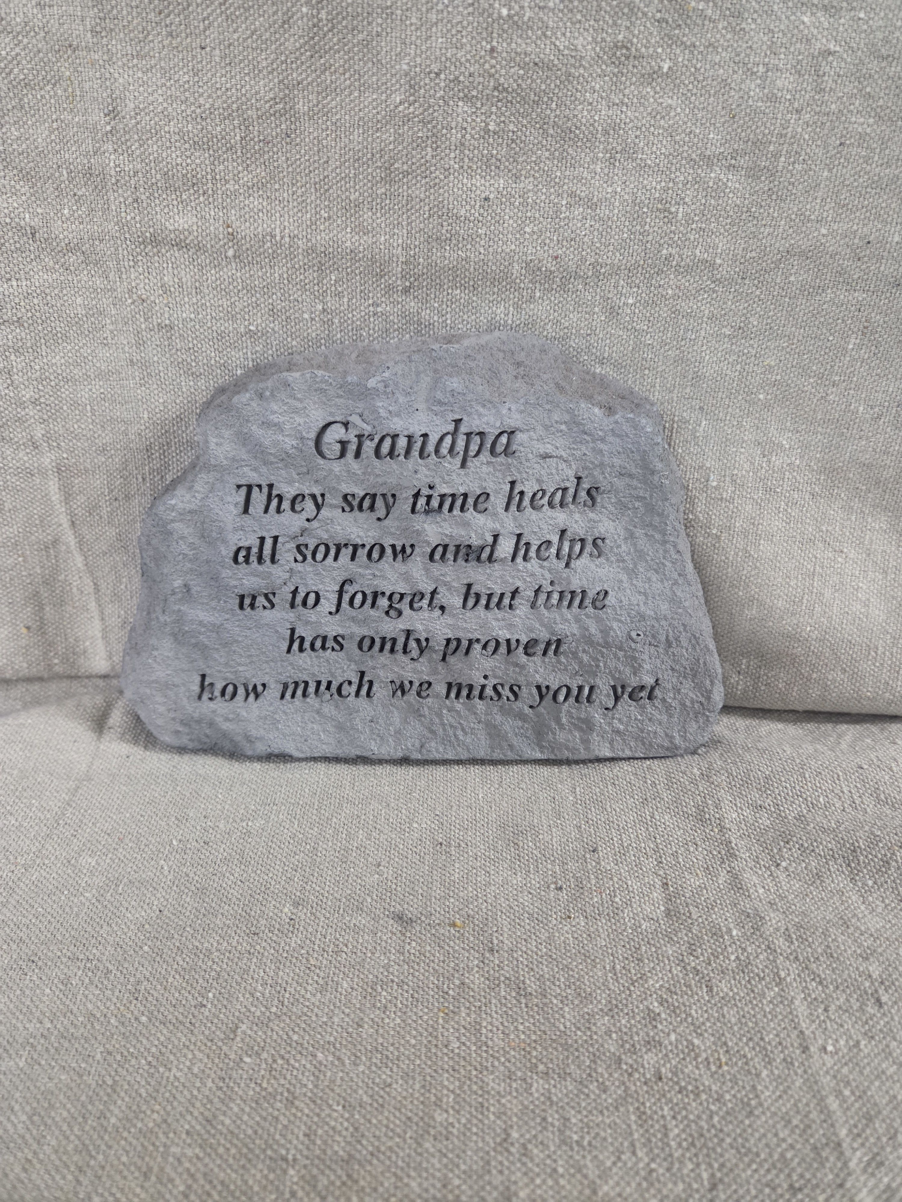 Gray memorial stone engraved with a sentimental message for a grandpa.