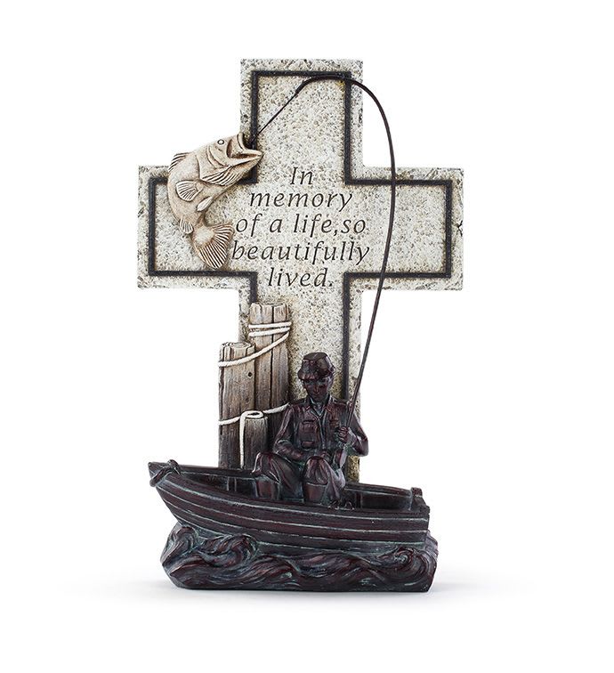 Memorial cross figurine with a fisherman in a boat and a leaping fish on a line