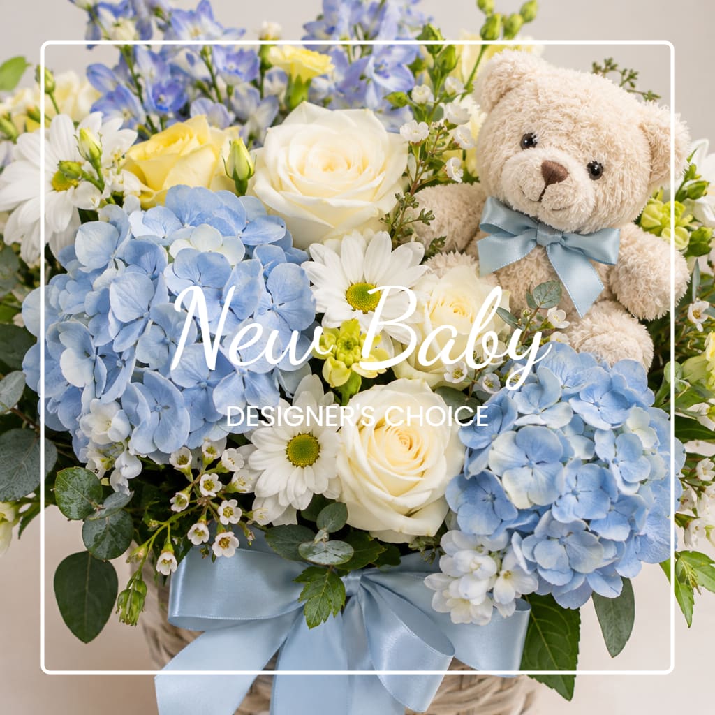 Blue and white flower arrangement with a teddy bear and ribbon in a basket