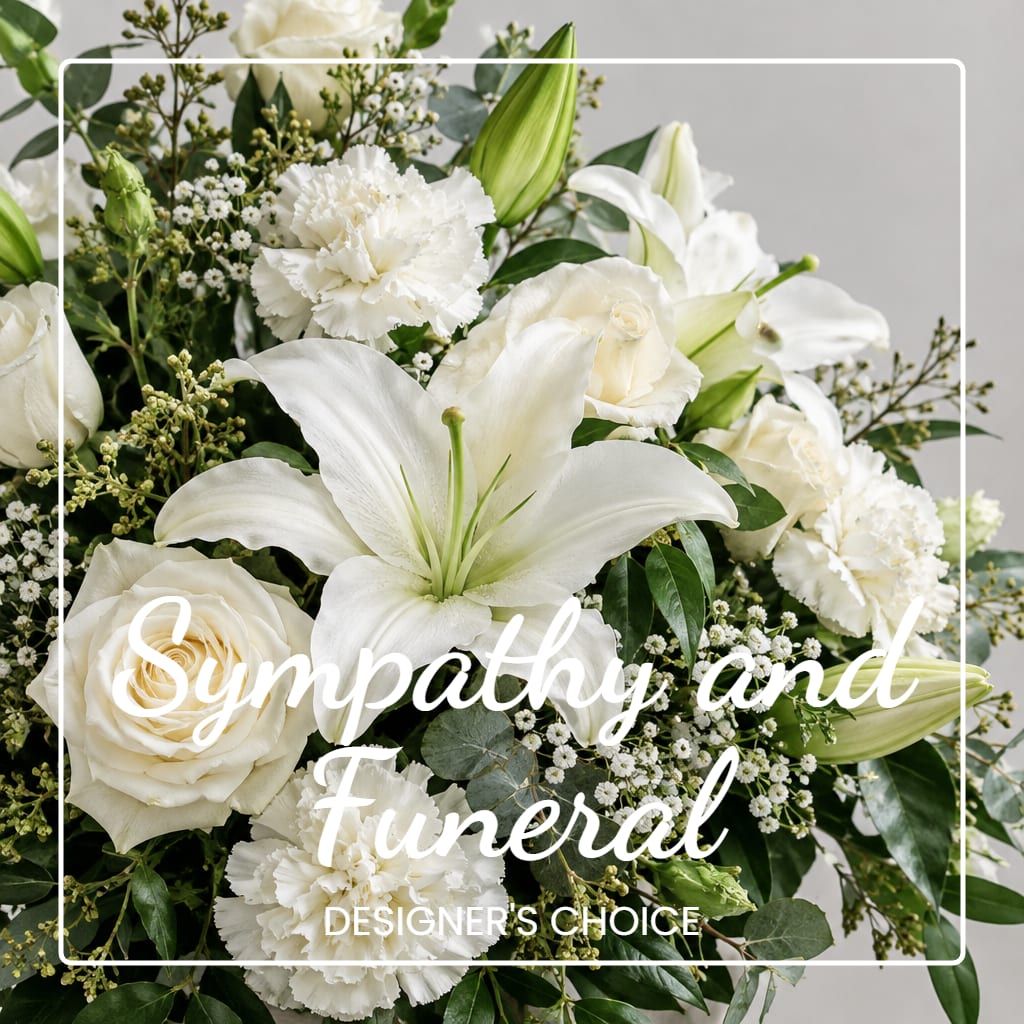 White sympathy floral arrangement with lilies, roses, and carnations