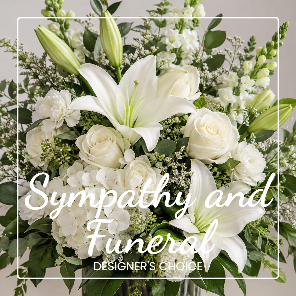 White lilies and roses in a sympathy floral arrangement
