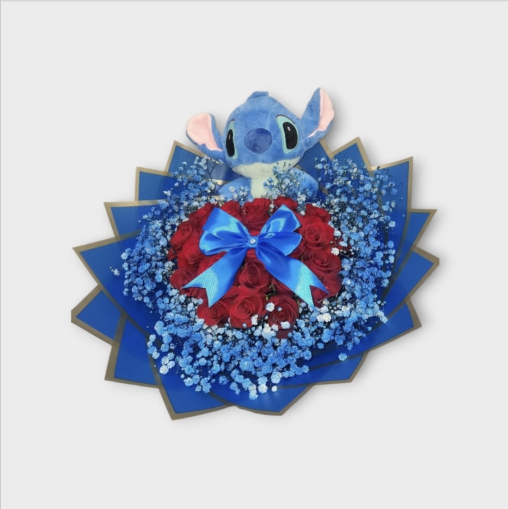 Plush Stitch toy above a bouquet of red roses with blue baby's breath and ribbon
