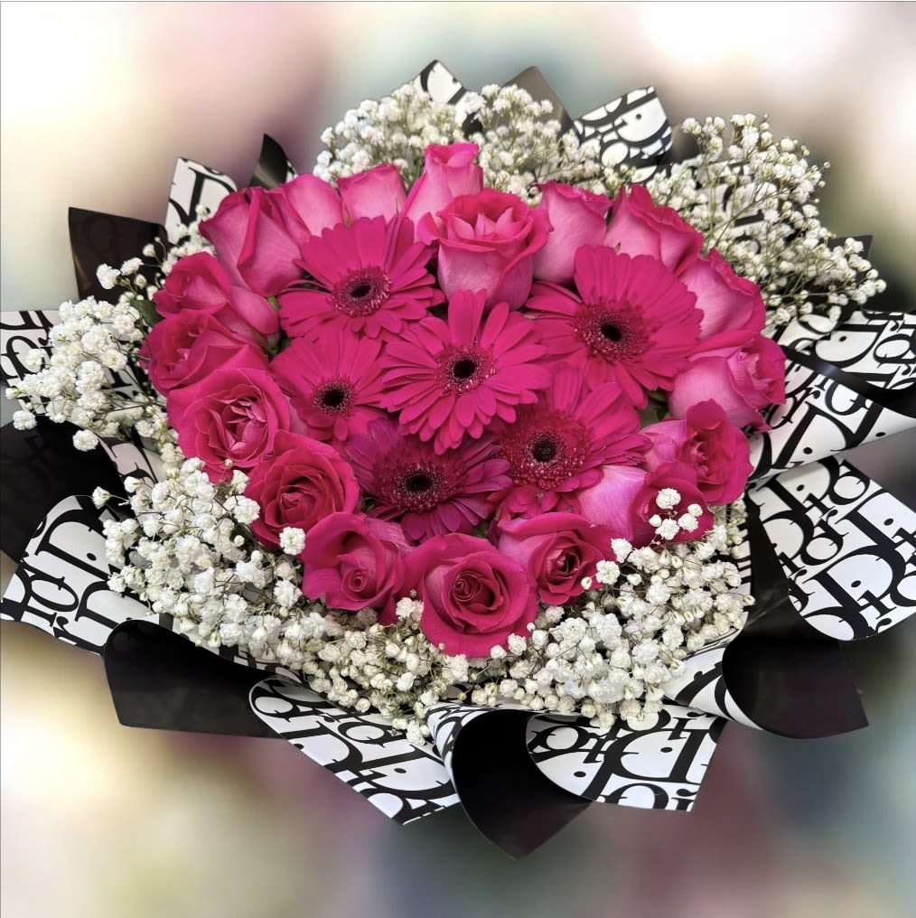Hot pink roses and gerbera daisies in a black-and-white wrap