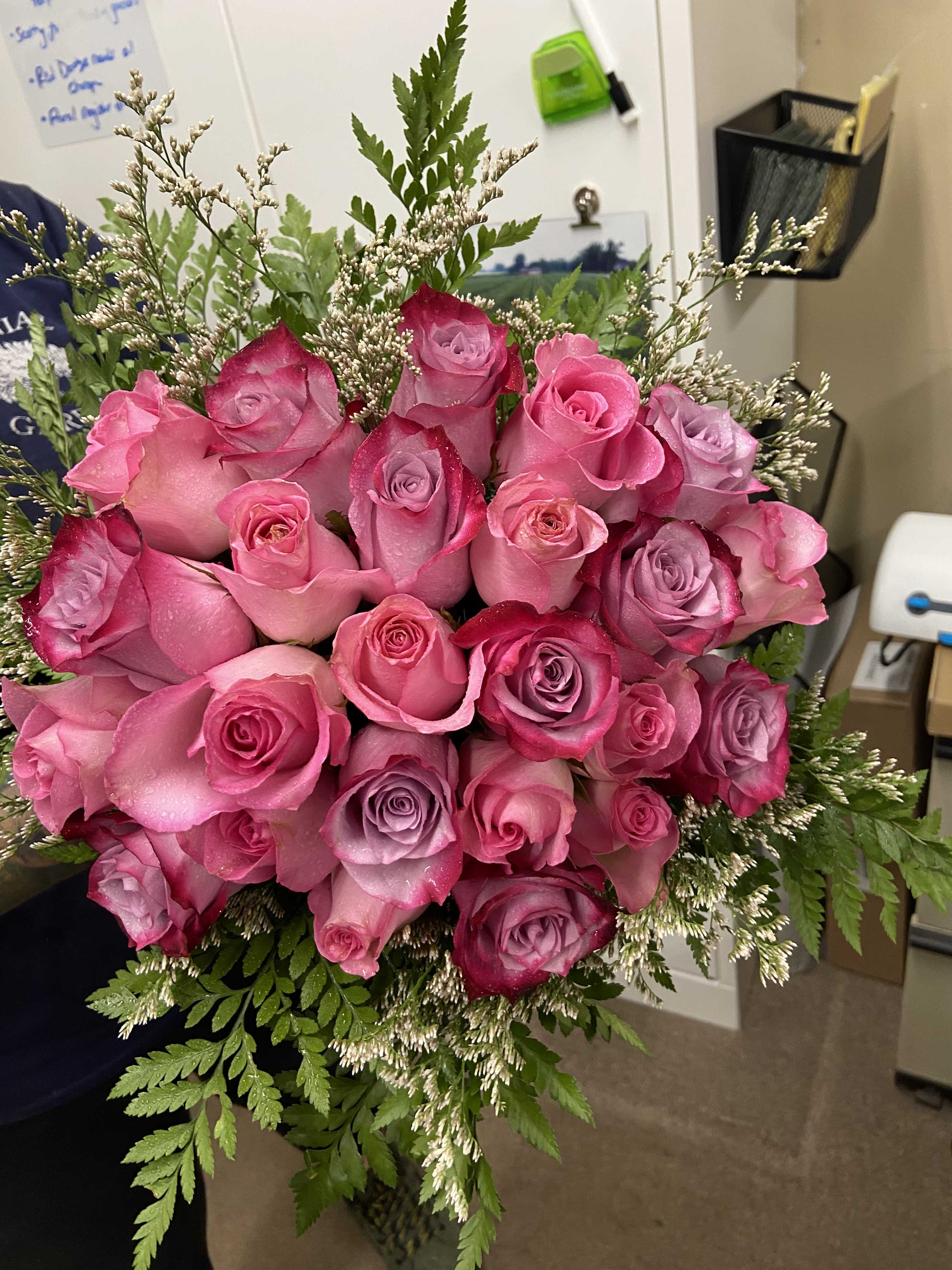 Bouquet of pink and lavender roses with fern filler