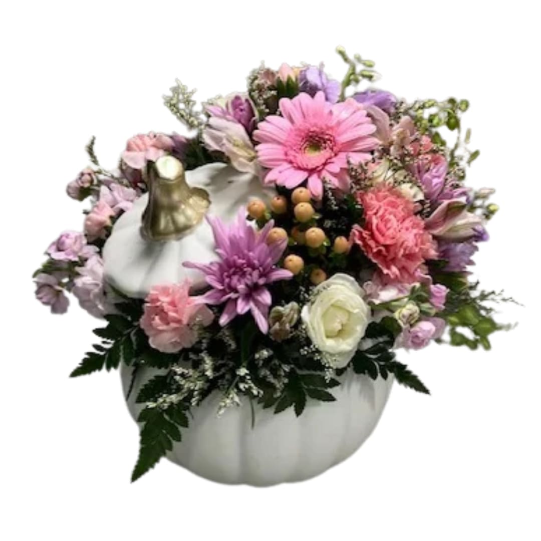 Pink and purple mixed bouquet arranged in a white pumpkin container
