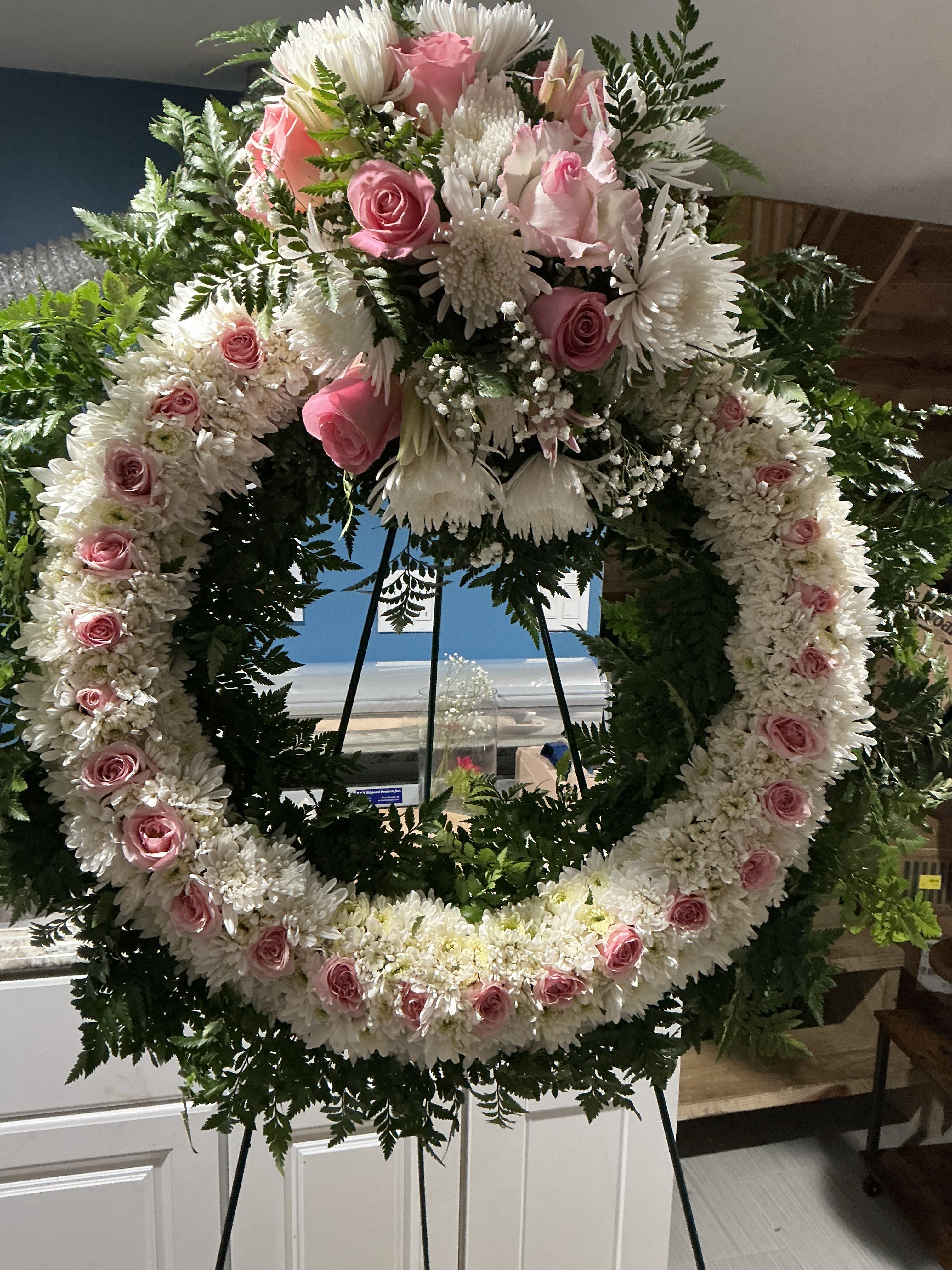 Our Respects - A beautiful white, pink, and green tribute wreath that calms This peaceful arrangement celebrates a full life passing 