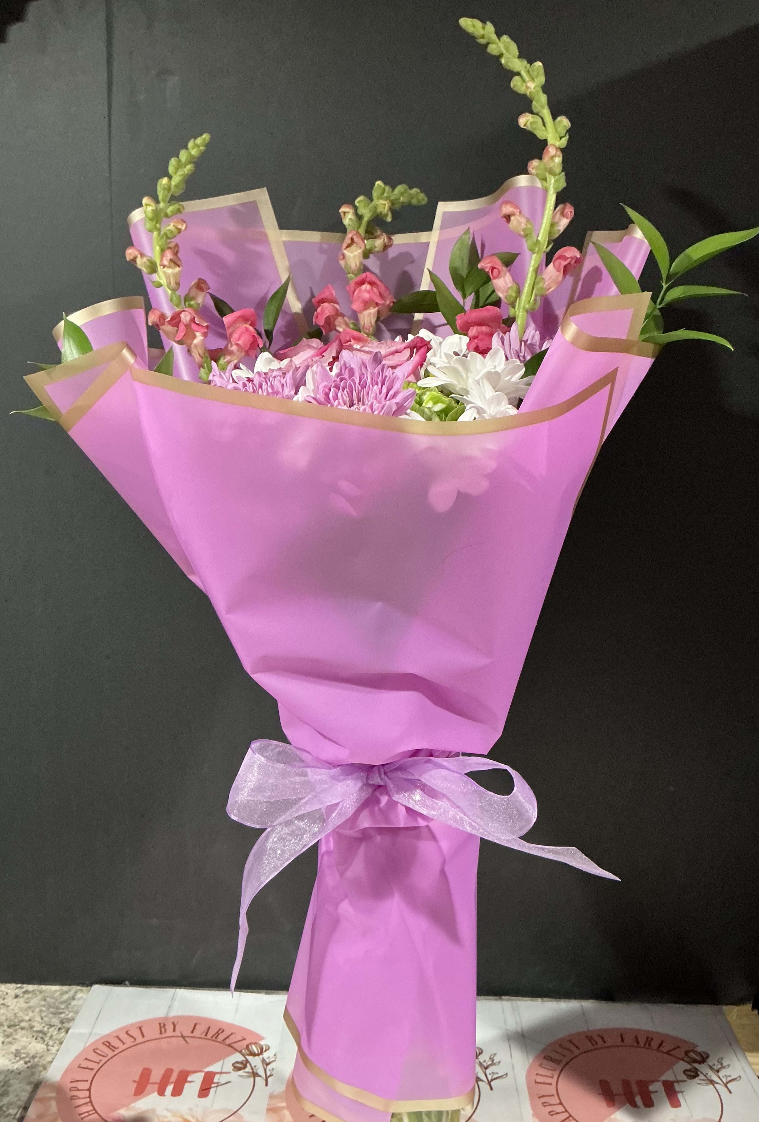 Purple Bouquet  - This purple floral bouquet it’s perfect gift for women day or any other special occasion    2Hydrangeas green  5 daisies 4 purple roses  3 snapdragon and ruscus Designed exclusive purple Korean wrapping paper  Vase no incluid   