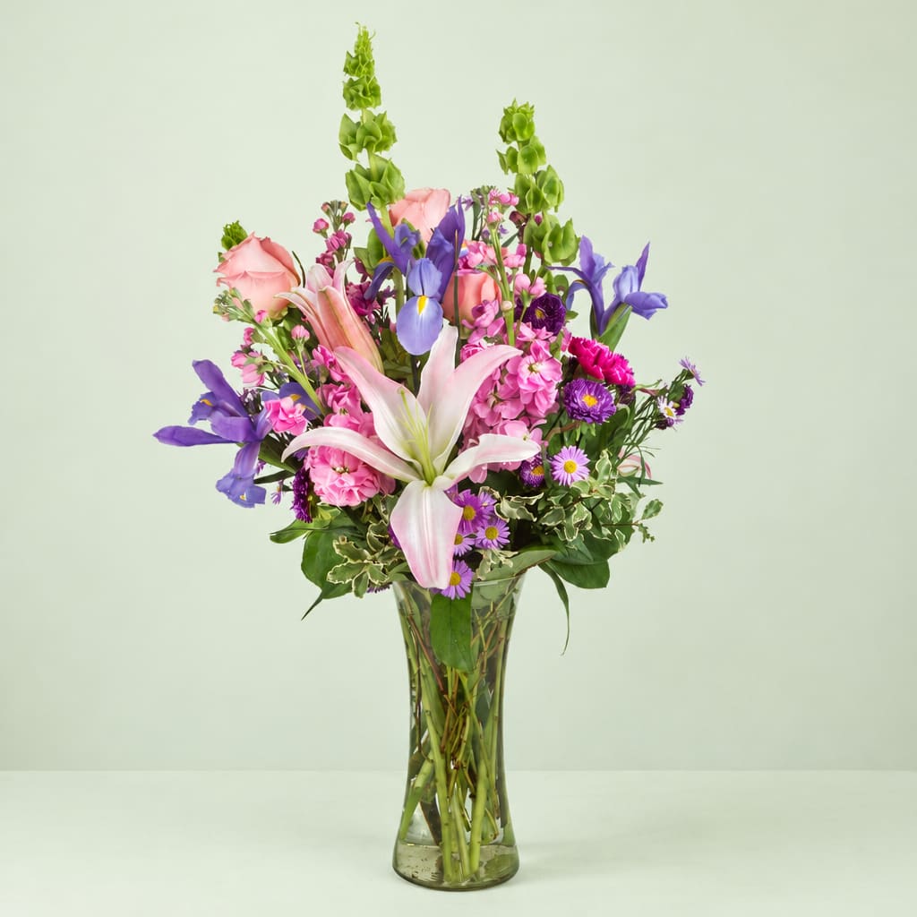 Pink and purple mixed bouquet in a clear glass vase