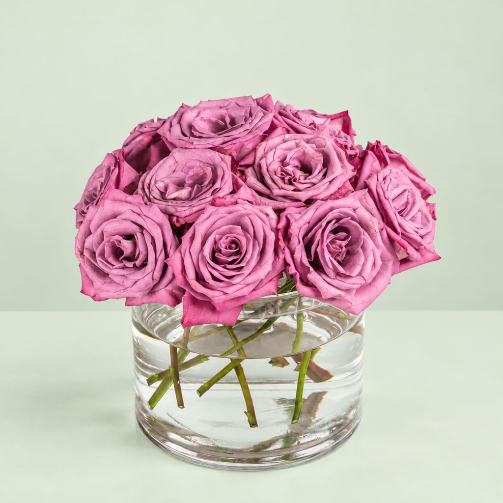 Pink roses arranged in a clear glass vase