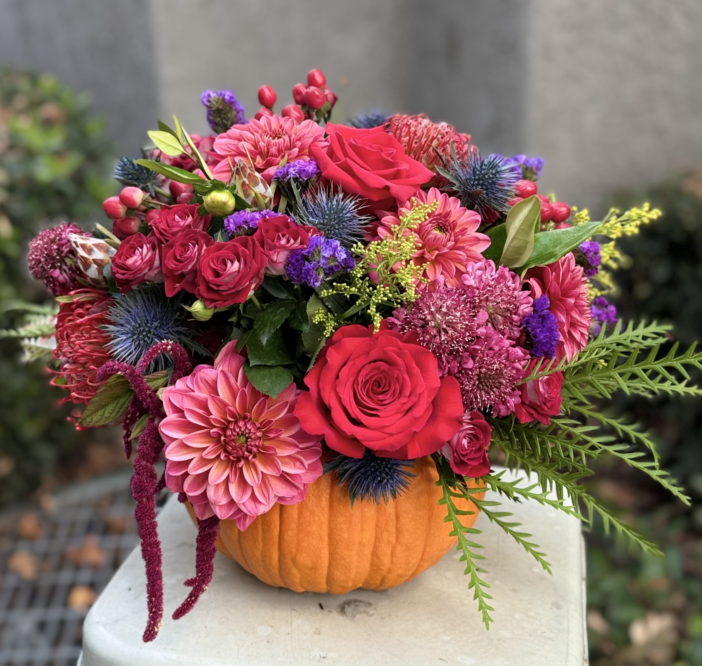 Bright mixed bouquet arranged in a pumpkin container