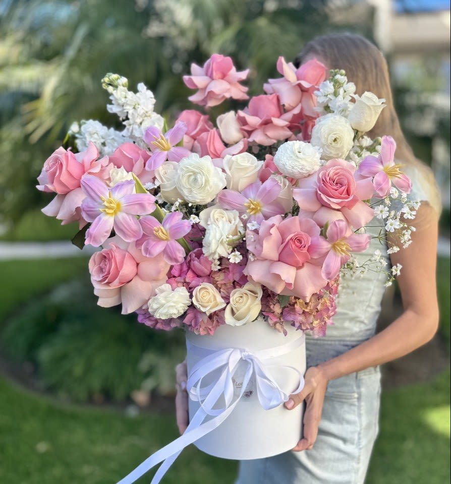 Large pink and white bouquet in a white hat box with ribbon