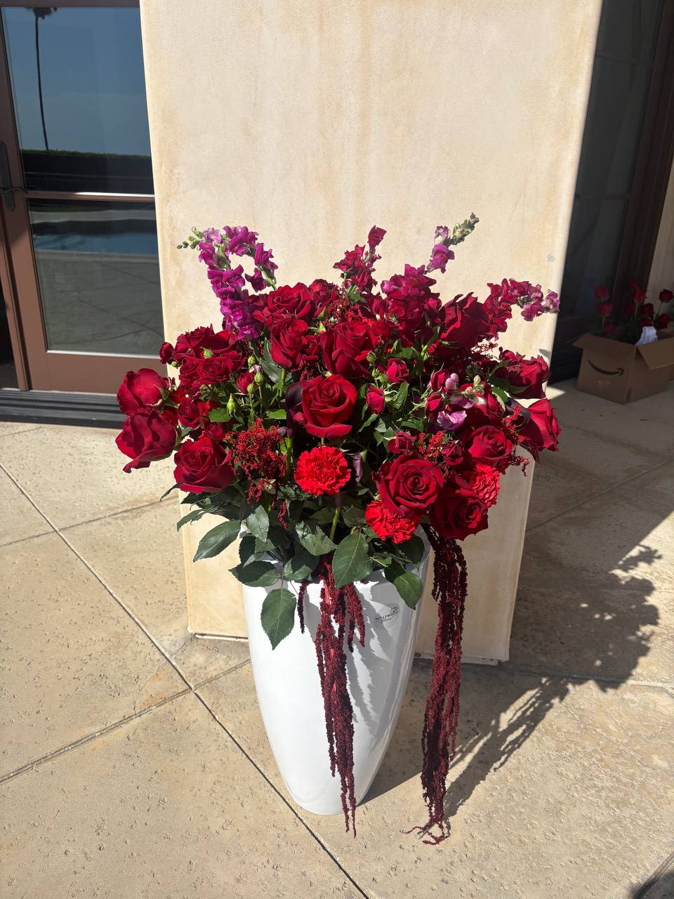 Luxury Velvet Romance - A bold statement floral arrangement designed for luxury events and unforgettable experiences. Featuring deep red roses and dramatic cascading textures, this design creates a striking focal point for weddings, private dinners, and upscale celebrations. Available for event styling and delivery in Los Angeles.