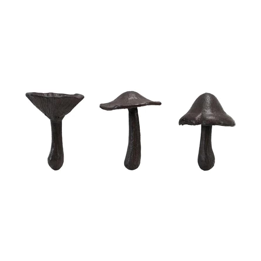Three dark mushroom-shaped decorative objects on a white background
