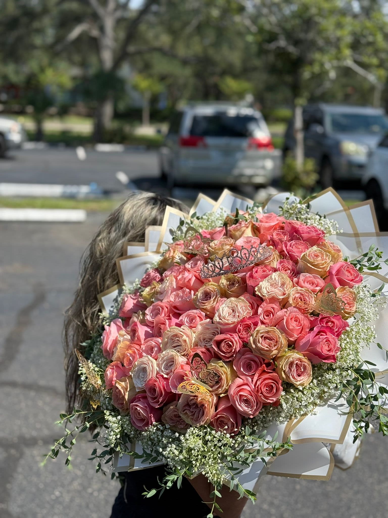 Large bouquet of pink and peach roses with white filler flowers