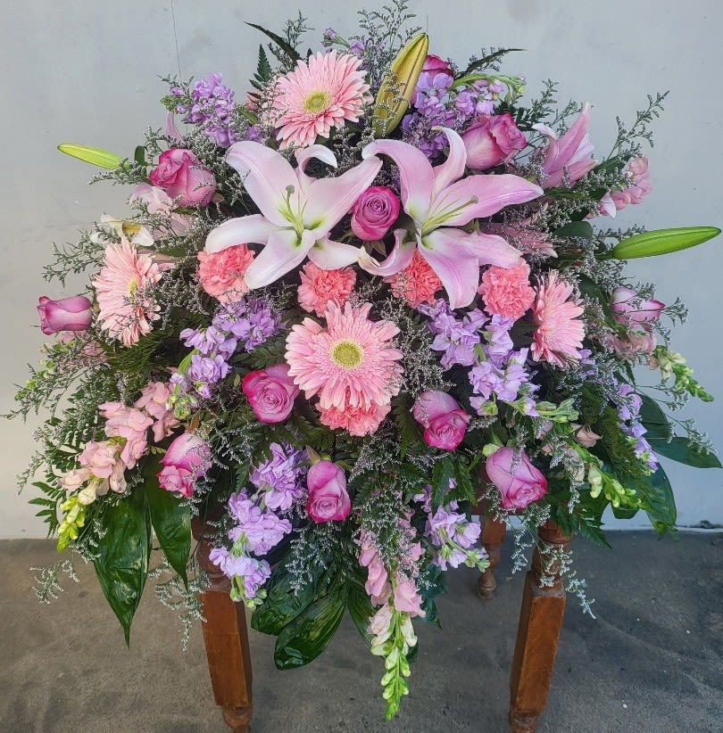 Large pink and purple floral spray with lilies and roses