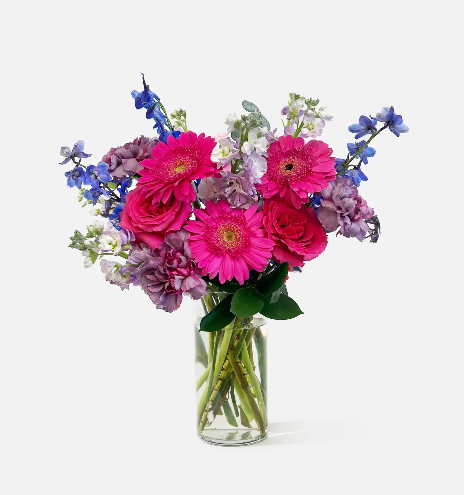 Bouquet of pink and purple flowers in a clear glass vase