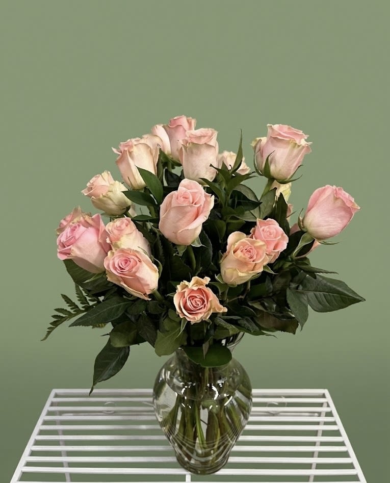 Pink roses arranged in a clear glass vase