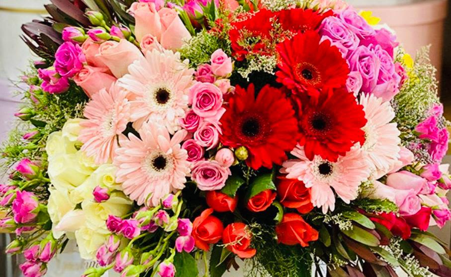 Mixed bouquet of pink, red, and white flowers