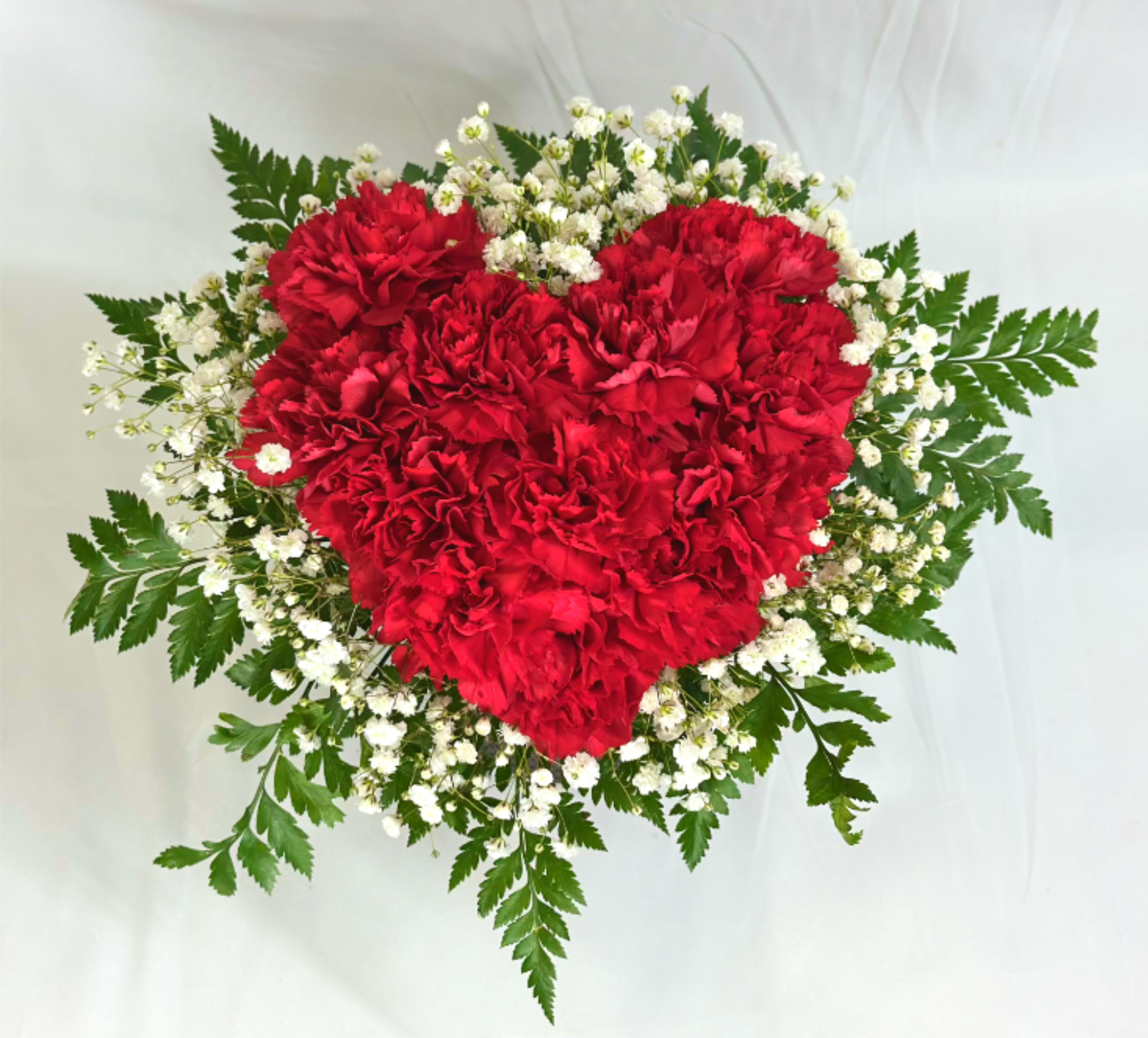 You Have My Heart - Nothing says Valentine's Day like hearts and flowers! This arrangement of bright red carnations and Baby's Breath highlights both! This would also make an adorable anniversary gift, or something special just for someone you love.  If the featured flowers are unavailable we will design your arrangement using the freshest blooms of equal or greater value