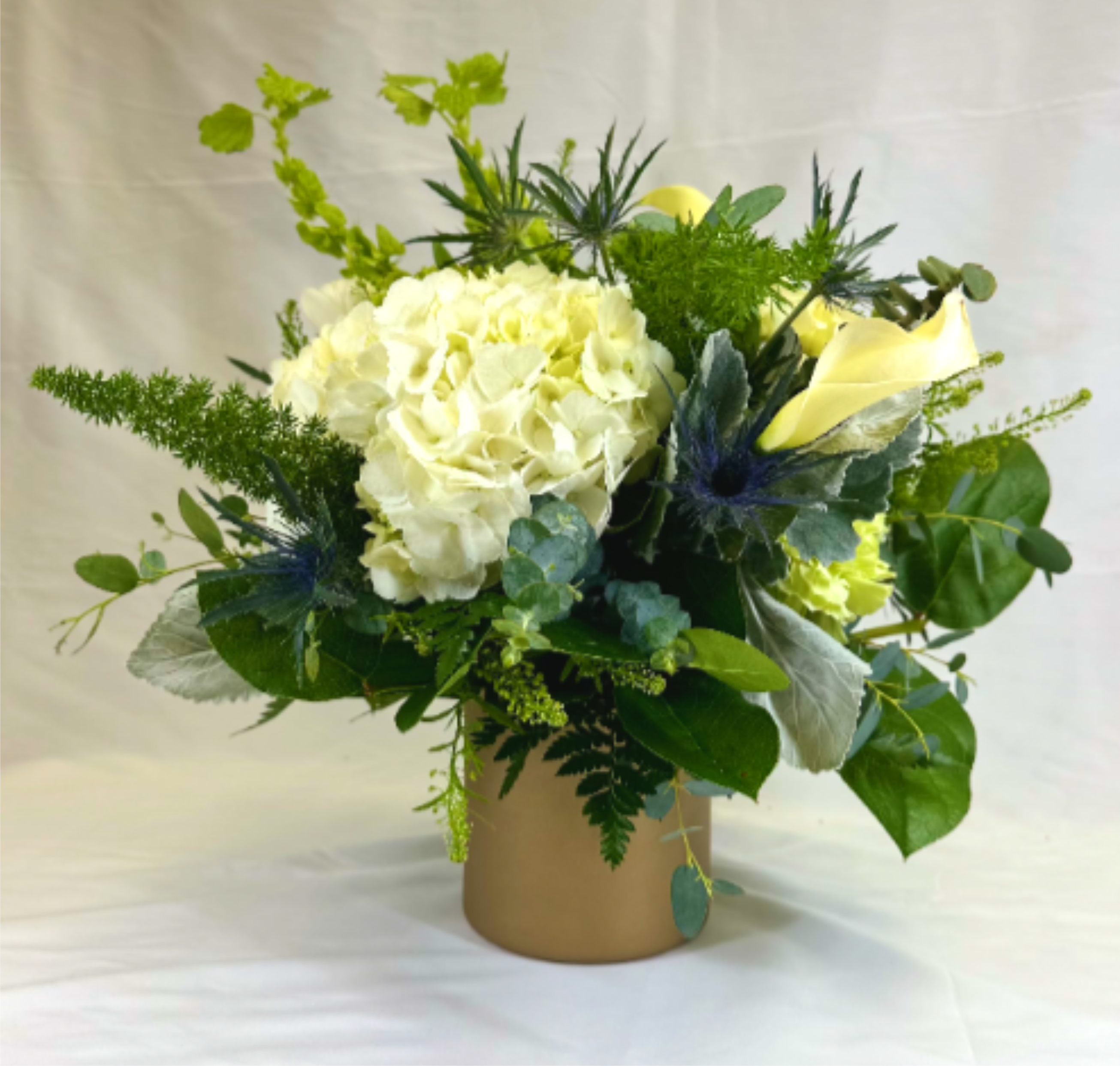 Leprechaun Magic - This Delightful Leary's Flowers original design is magical in shades of cream and green. It will bring good luck on St. Patrick's Day, or look beautiful any time of year. If the featured flowers are unavailable we will design your arrangement using the freshest blooms available of equal or greater value