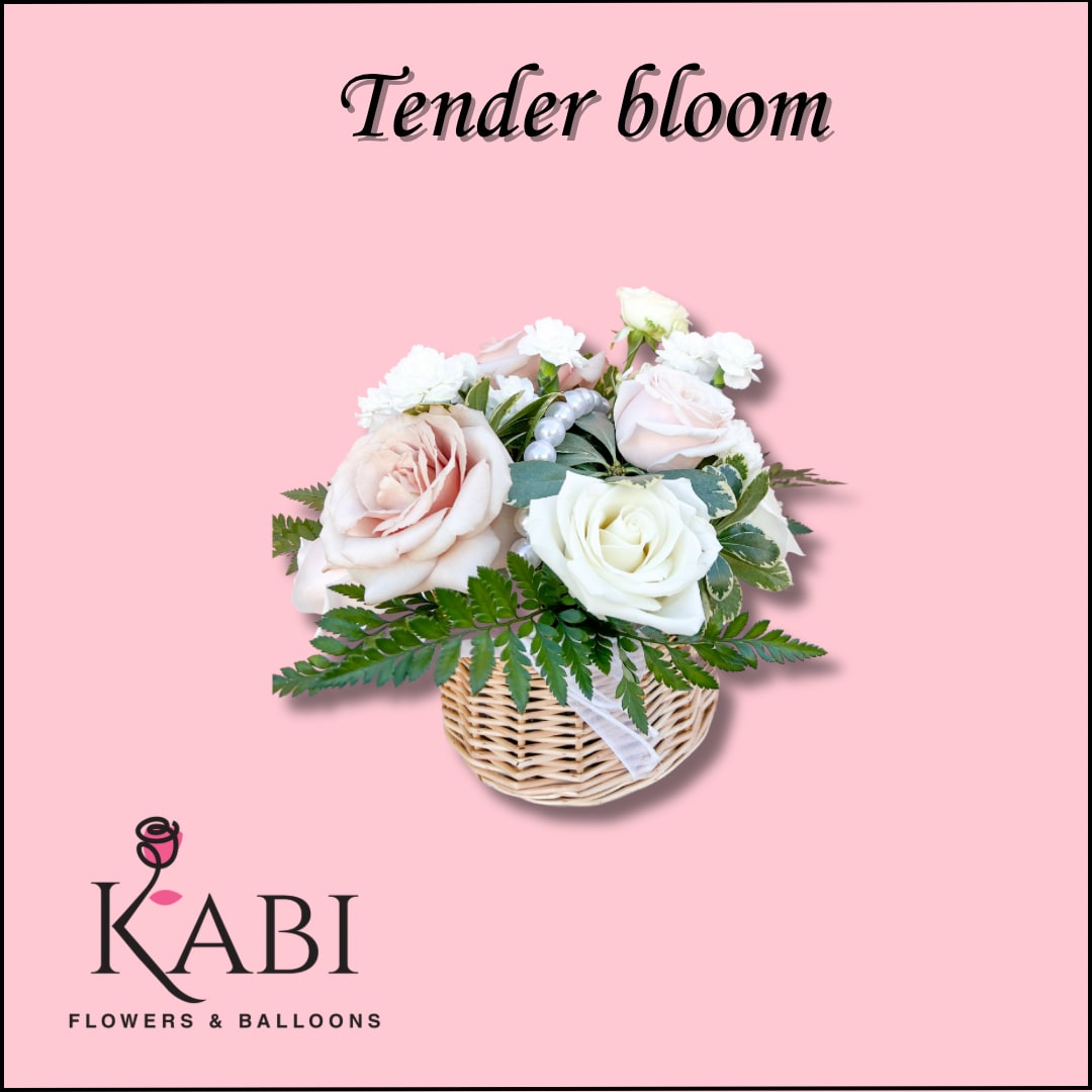 Pink and white rose arrangement in a wicker basket