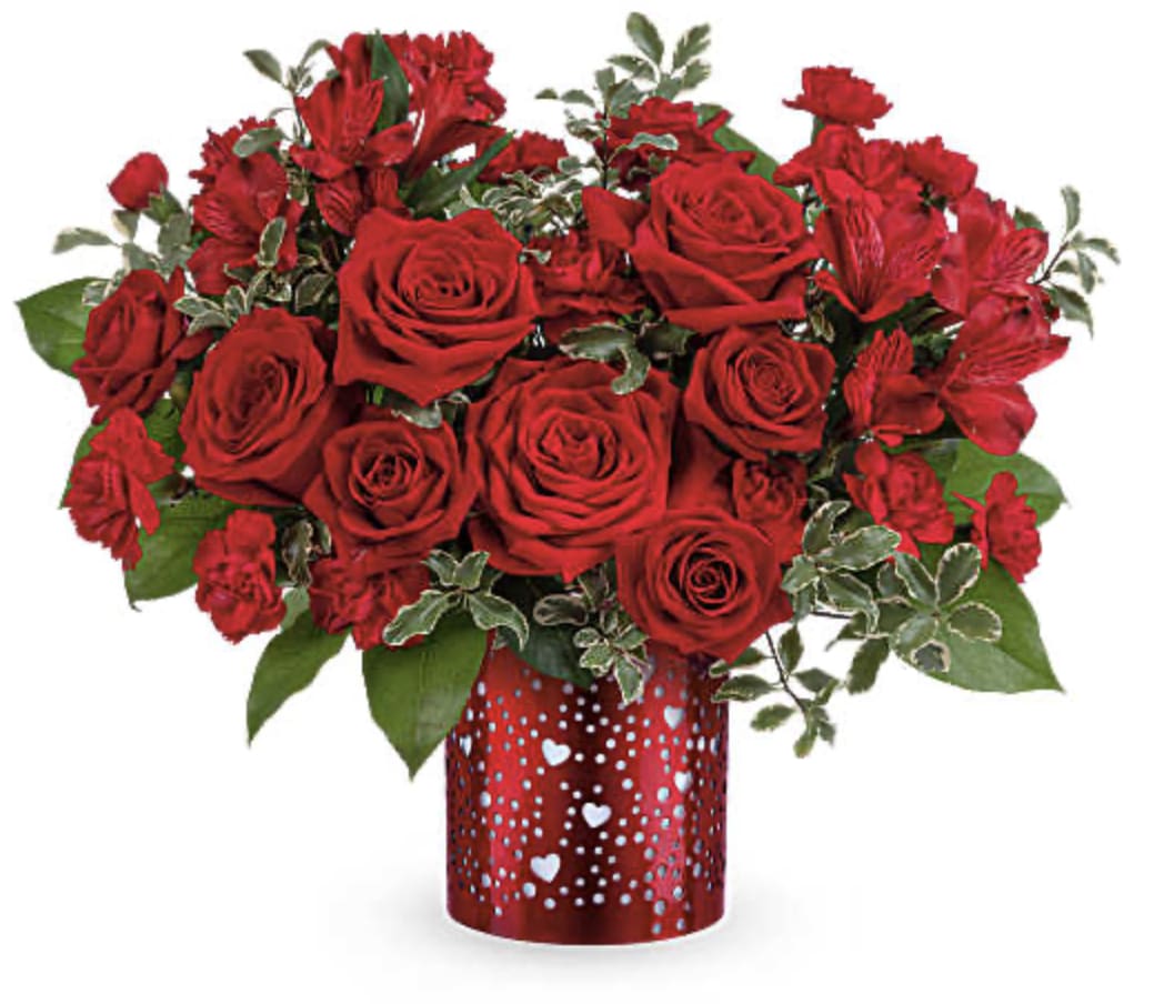 Red roses and red alstroemeria in a heart-patterned vase