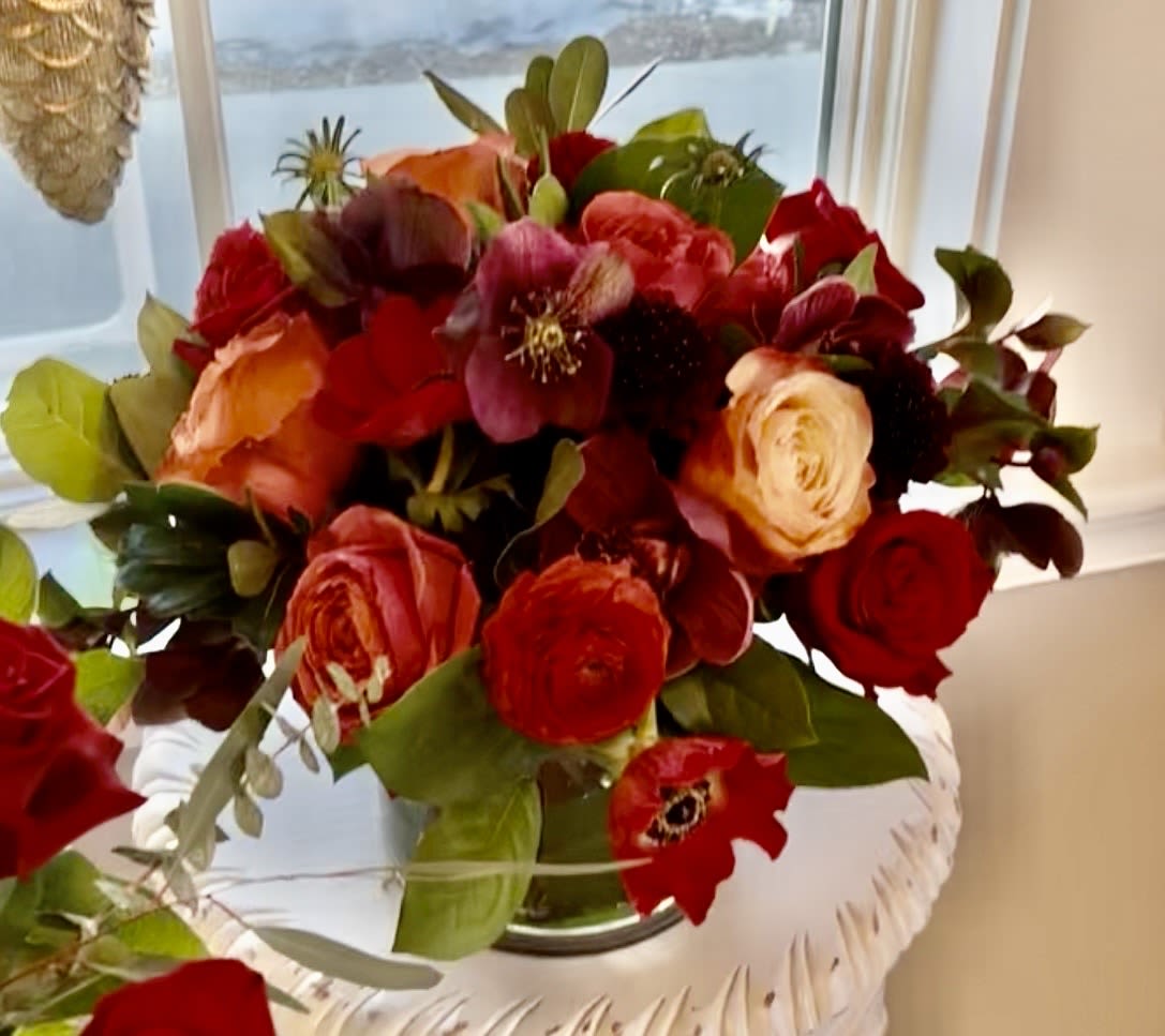 Cozy  - Roses, scabiosa, ranunculus, thistle, hellebores and anemones in shades of  red, coral, burgundy and green.
