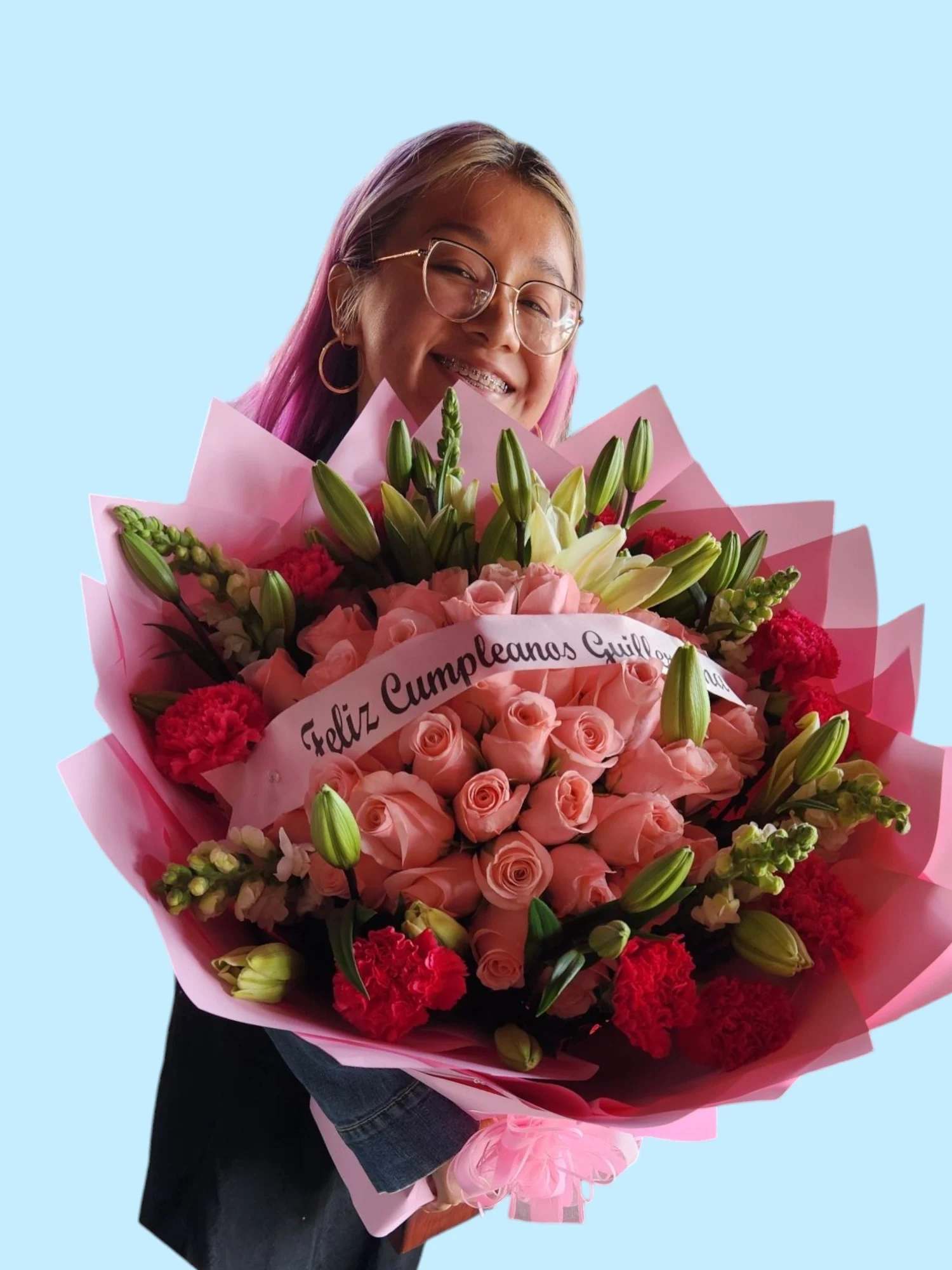 Woman holding a large bouquet of pink roses and lilies