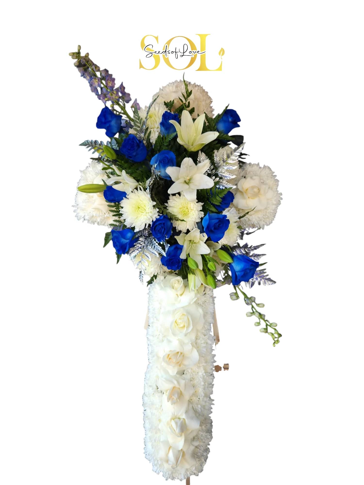 Tall white floral standing spray with blue roses and lilies