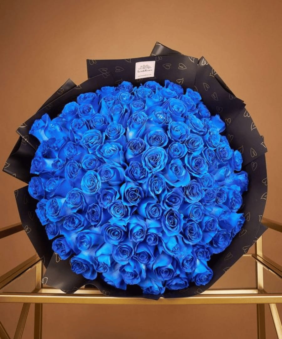 Large bouquet of vivid blue roses wrapped in black paper