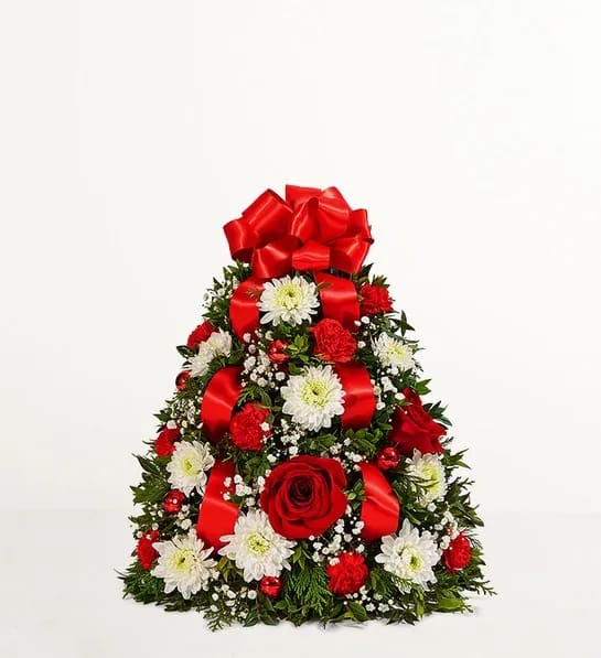 Triangular floral arrangement with red bows, red roses, and white daisies