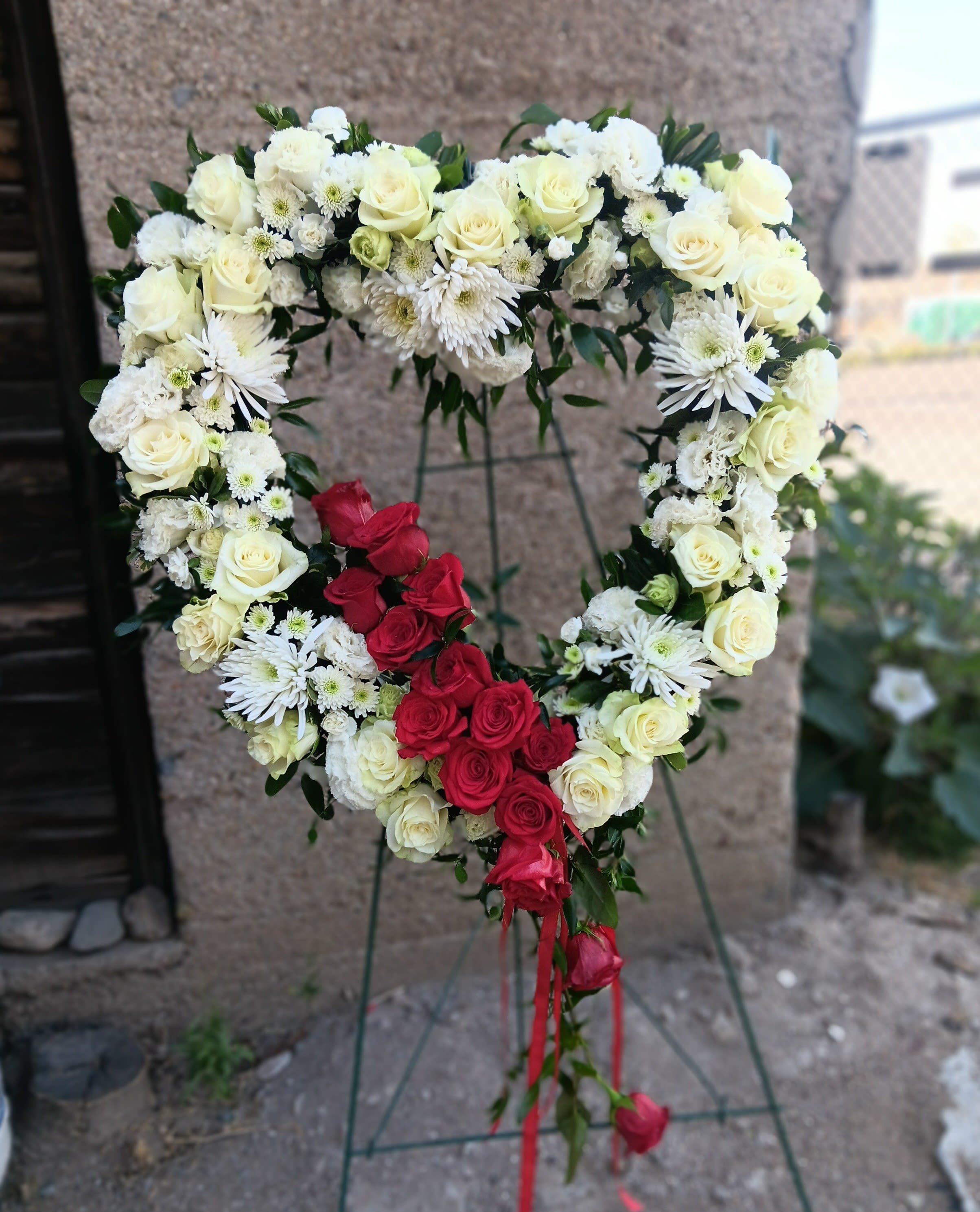 Bleeding Heart - Garden mix of white flowers with a dozen red roses and red ribbons to give the bleeding heart look.