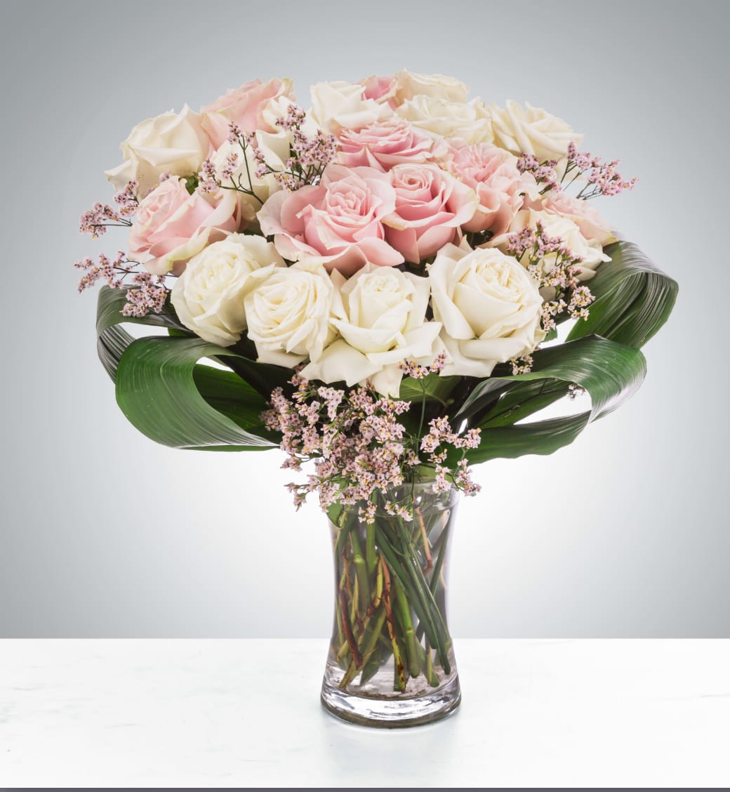 Luxury Love - Luxury Love is a soft and extravagant rose arrangement that will surely make the recipient gasp. With white and blush roses, this arrangement is pure class and elegance and will surely wow.  Approximate Dimensions: 18"D x 22"H