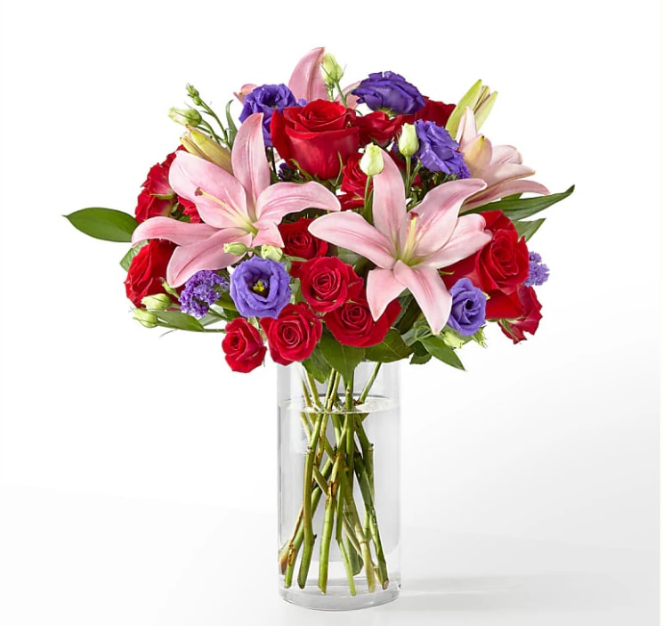 Truly Stunning Bouquet - This dreamy jewel toned bouquet combines bold color and eye catching texture to make a statement. Featuring a thoughtful array of both roses and lilies, this dazzling assortment is bound to impress your recipient. FTD design.