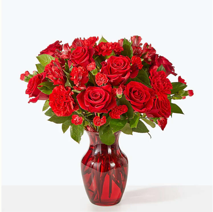 The Heartstrings Bouquet - A valentine in bloom, this all red arrangement of roses, carnations and alstroemeria is the perfect way to celebrate an anniversary, holiday or simply remind them they are loved. FTD Design.