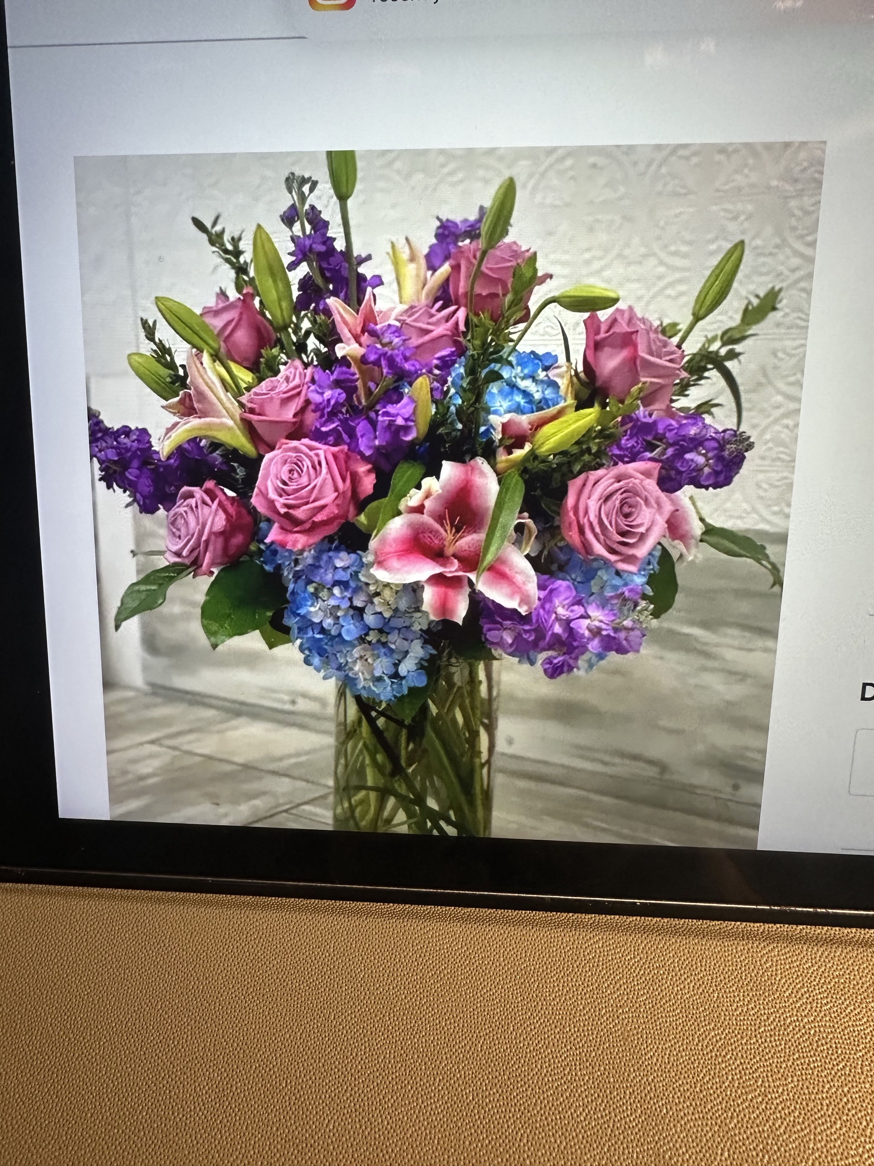 Tall vase arrangement with pink roses, lilies, purple stock, and blue hydrangeas
