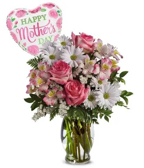 Pink and white bouquet with roses and daisies in a glass vase and a Happy Mother's Day balloon.