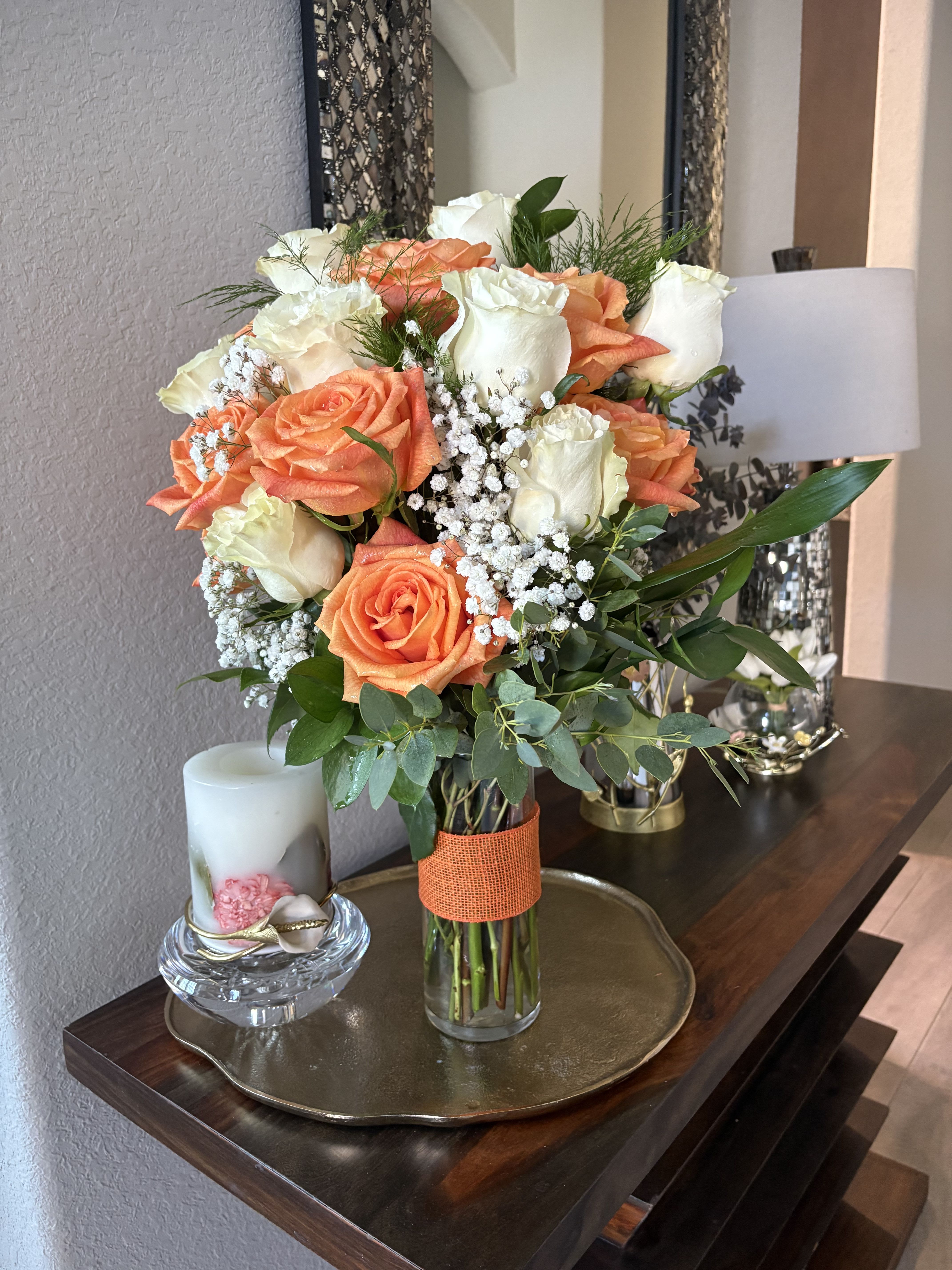 Bouquet of peach and white roses in a glass vase
