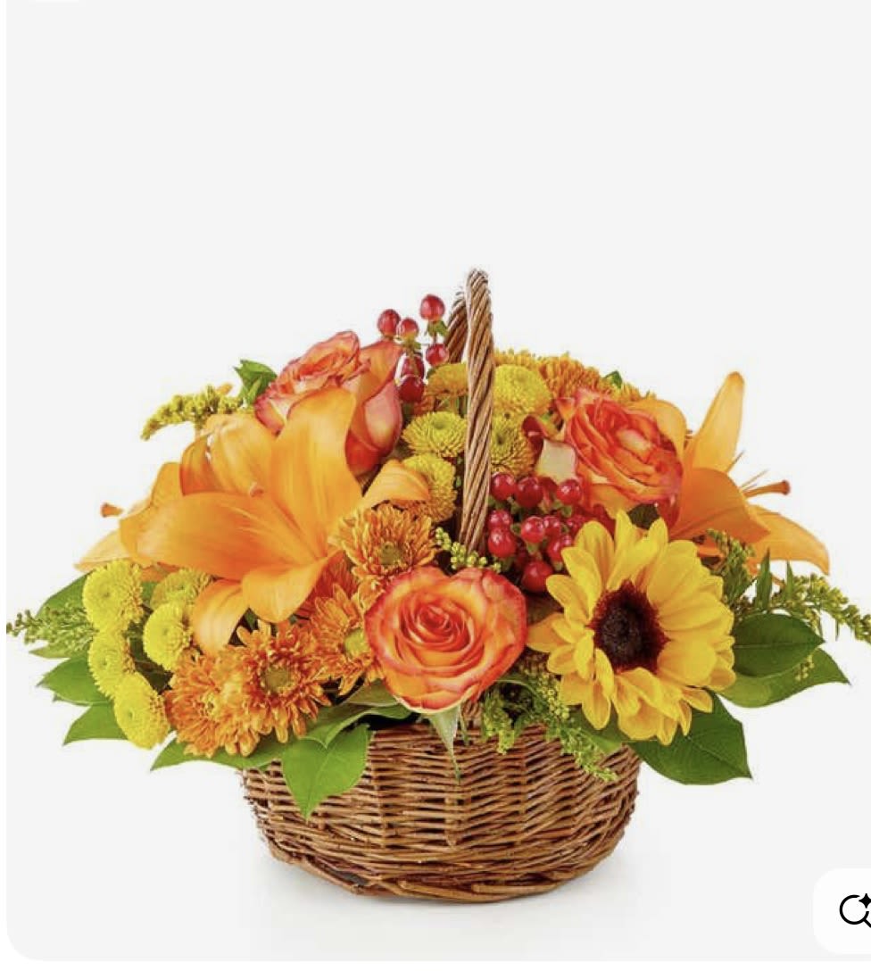Basket of orange and yellow flowers with roses and lilies
