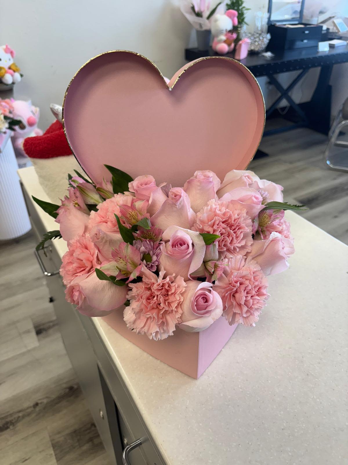 Pink rose and carnation arrangement in a heart-shaped box