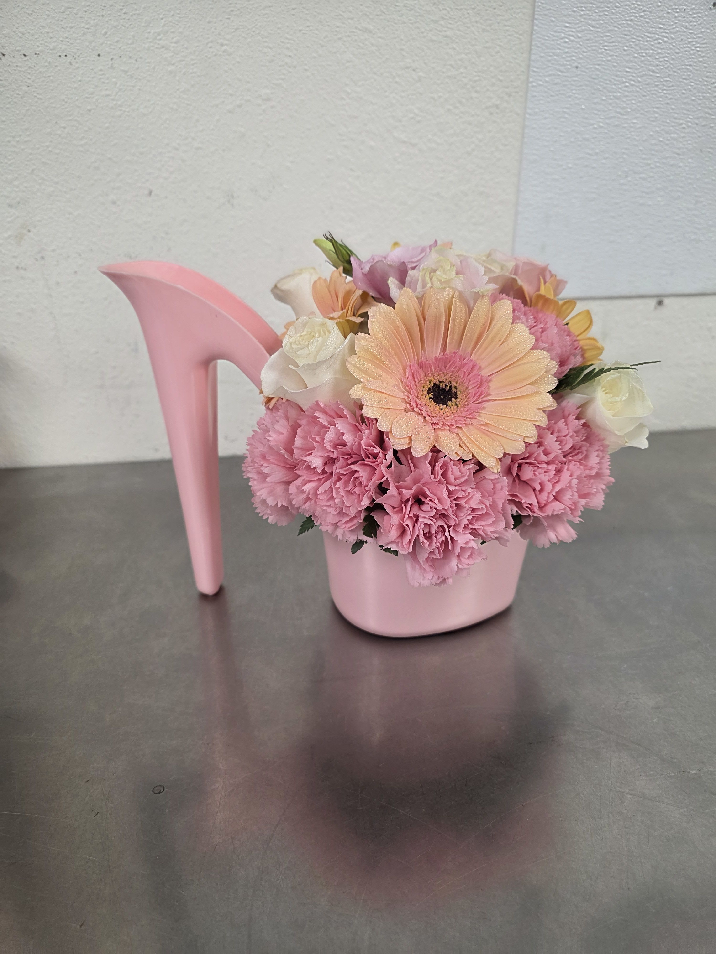 Pink floral arrangement in a pink high-heel shoe container