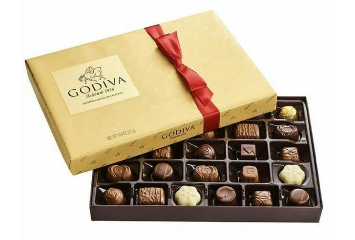 Box of assorted chocolates with a red ribbon