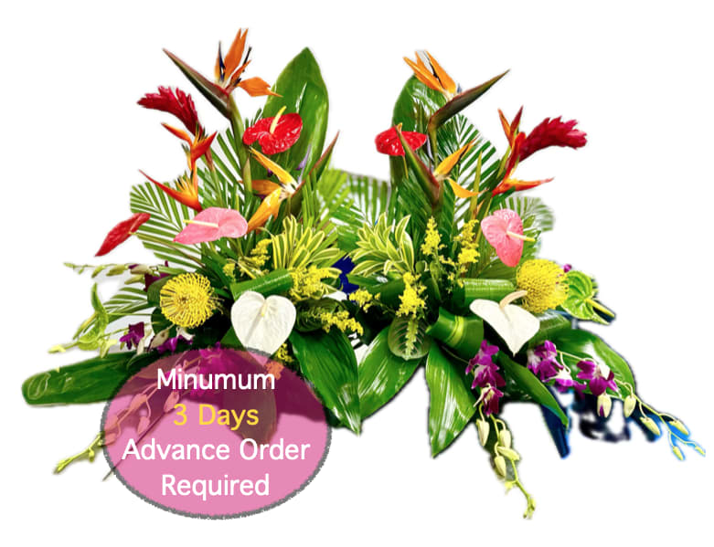 Tropical floral arrangement with red, pink, yellow, and white blooms