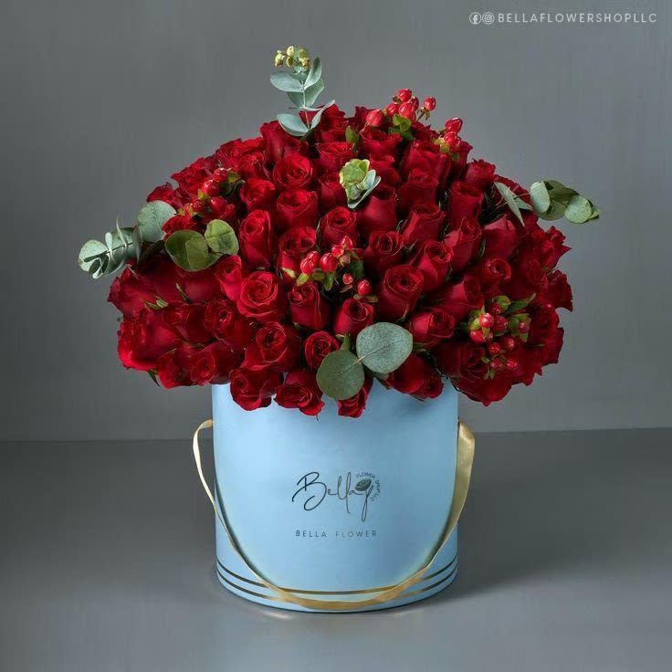 Large bouquet of red roses in a light blue hatbox