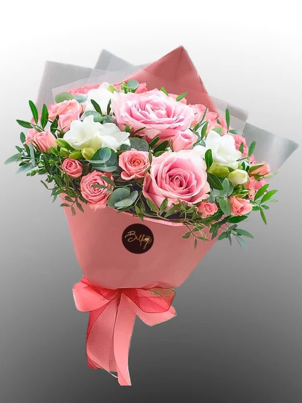 Pink and white rose bouquet wrapped in pink paper with a ribbon