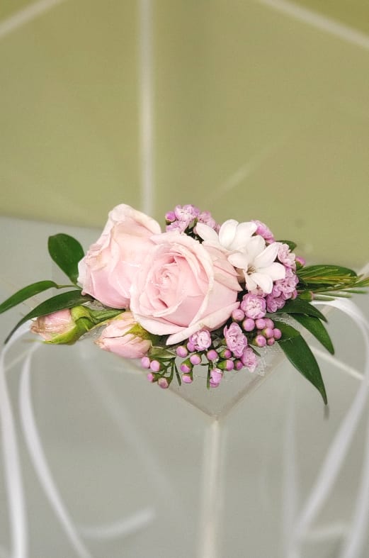 Pink rose corsage with white daisy and purple accents