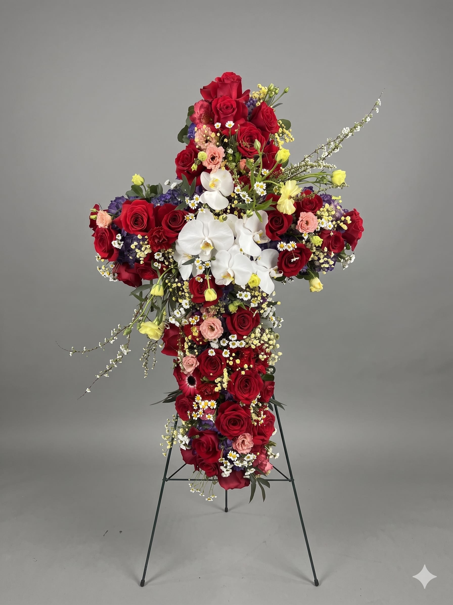BP58 - Eternal Grace Cross - A heartfelt funeral tribute featuring vibrant red roses and delicate white blooms, elegantly arranged in the shape of a cross to symbolize faith, love, and remembrance.